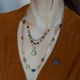 Green yellow jade long diamond hangs from gold filled box chain, with a layer of cat's eye gemstones, and a layer of oxidized sterling silver chain necklace