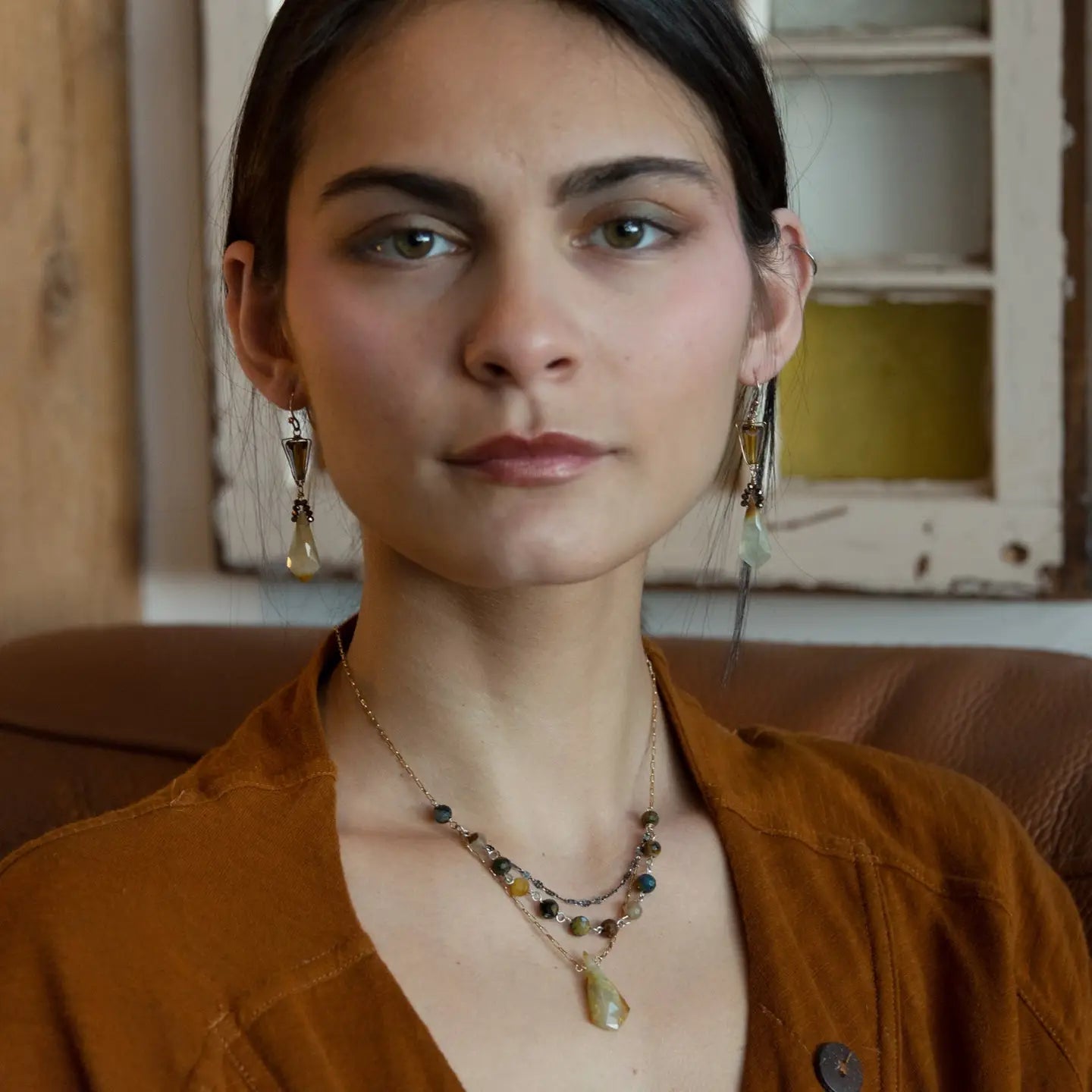 Green yellow jade long diamond hangs from gold filled box chain, with a layer of cat's eye gemstones, and a layer of oxidized sterling silver chain necklace