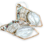 Quartz ovals surrounded by pyrite and crystal gemstones on sterling silver wire within a bronze parallelogram shape earrings