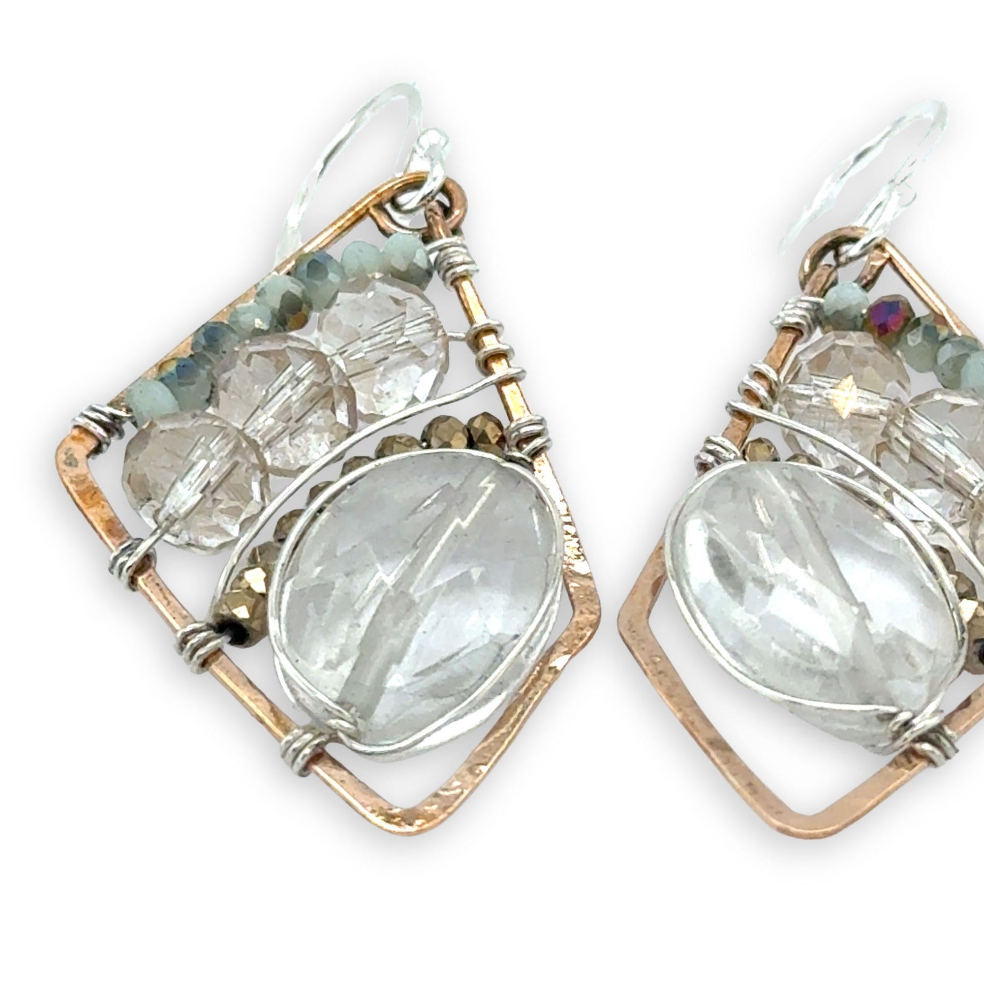Quartz ovals surrounded by pyrite and crystal gemstones on sterling silver wire within a bronze parallelogram shape earrings