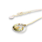 Sterling silver braided wire circle pendant filled with rutilated quartz and green cubic zirconia gemstones on gold filled wire and a 14k gold filled chain necklace