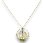 Sterling silver braided wire circle pendant filled with rutilated quartz and green cubic zirconia gemstones on gold filled wire and a 14k gold filled chain necklace