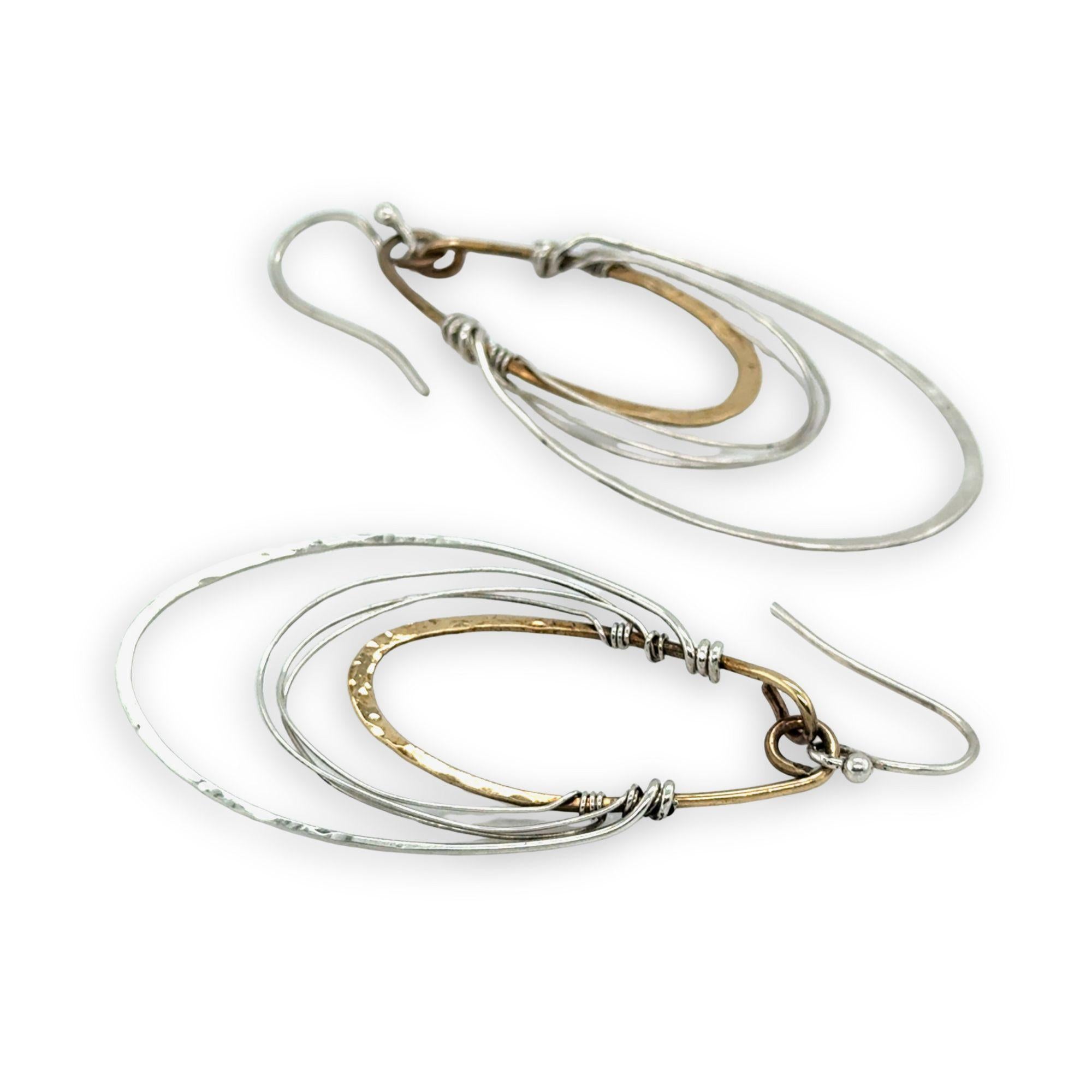 handmade bronze mini ovals with hammered sterling silver larger oval and fine sterling silver webbing in between 