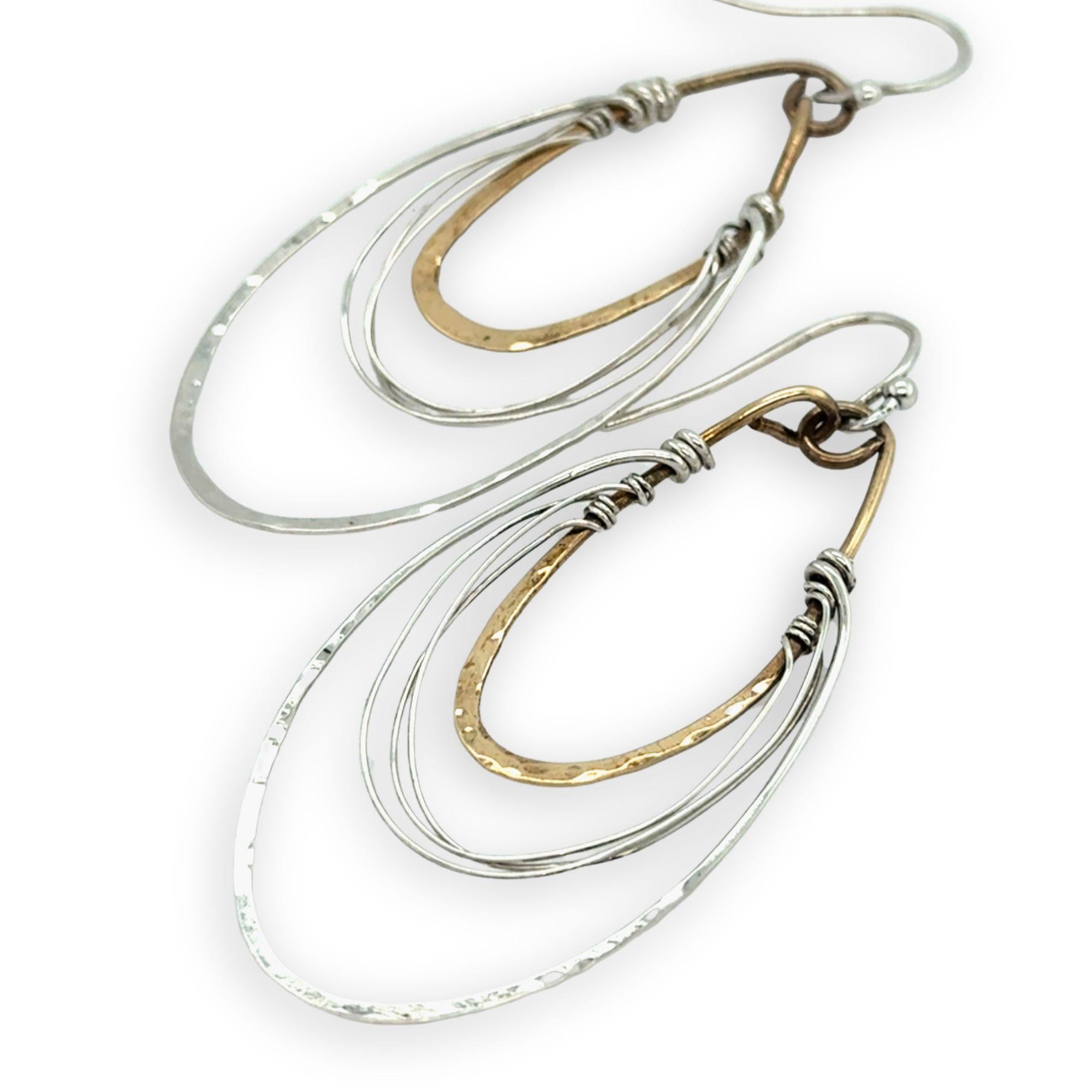 handmade bronze mini ovals with hammered sterling silver larger oval and fine sterling silver webbing in between 