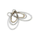 handmade bronze mini ovals with hammered sterling silver larger oval and fine sterling silver webbing in between 
