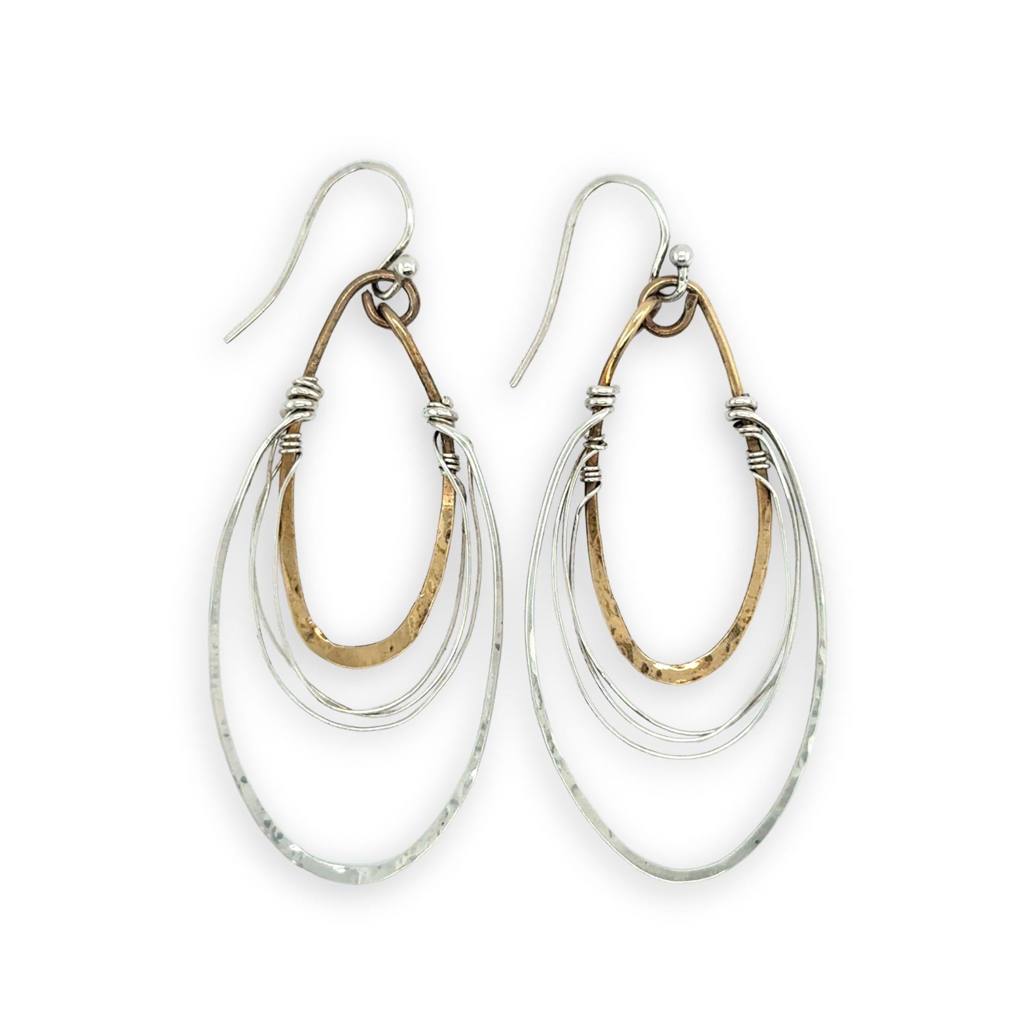 handmade bronze mini ovals with hammered sterling silver larger oval and fine sterling silver webbing in between 