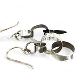 Hammered darkened sterling silver handmade rings connected to each other to create a chain effect