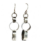 Hammered darkened sterling silver handmade rings connected to each other to create a chain effect