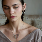 Two prehnite faceted gemstone drops are held within layers of mixed tourmaline, sterling silver, and bronze hammered metal to form our rainbows of tourmaline necklace