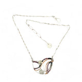 Two prehnite faceted gemstone drops are held within layers of mixed tourmaline, sterling silver, and bronze hammered metal to form our rainbows of tourmaline necklace