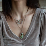 Two prehnite faceted gemstone drops are held within layers of mixed tourmaline, sterling silver, and bronze hammered metal to form our rainbows of tourmaline necklace