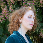 Turquoise and hemimorphite gemstones wrapped in sterling silver attached to a skinny bronze drop earring