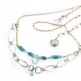 A handmade hammered sterling silver link double chain necklace with gold filled delicate chain, turquoise, blue quartz, and opal gemstones