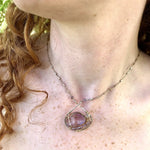 raw amethyst nugget is held in brass and gold filled wire with faceted amethyst and labradorite gemstones accents all inside a sterling silver pendant pendant