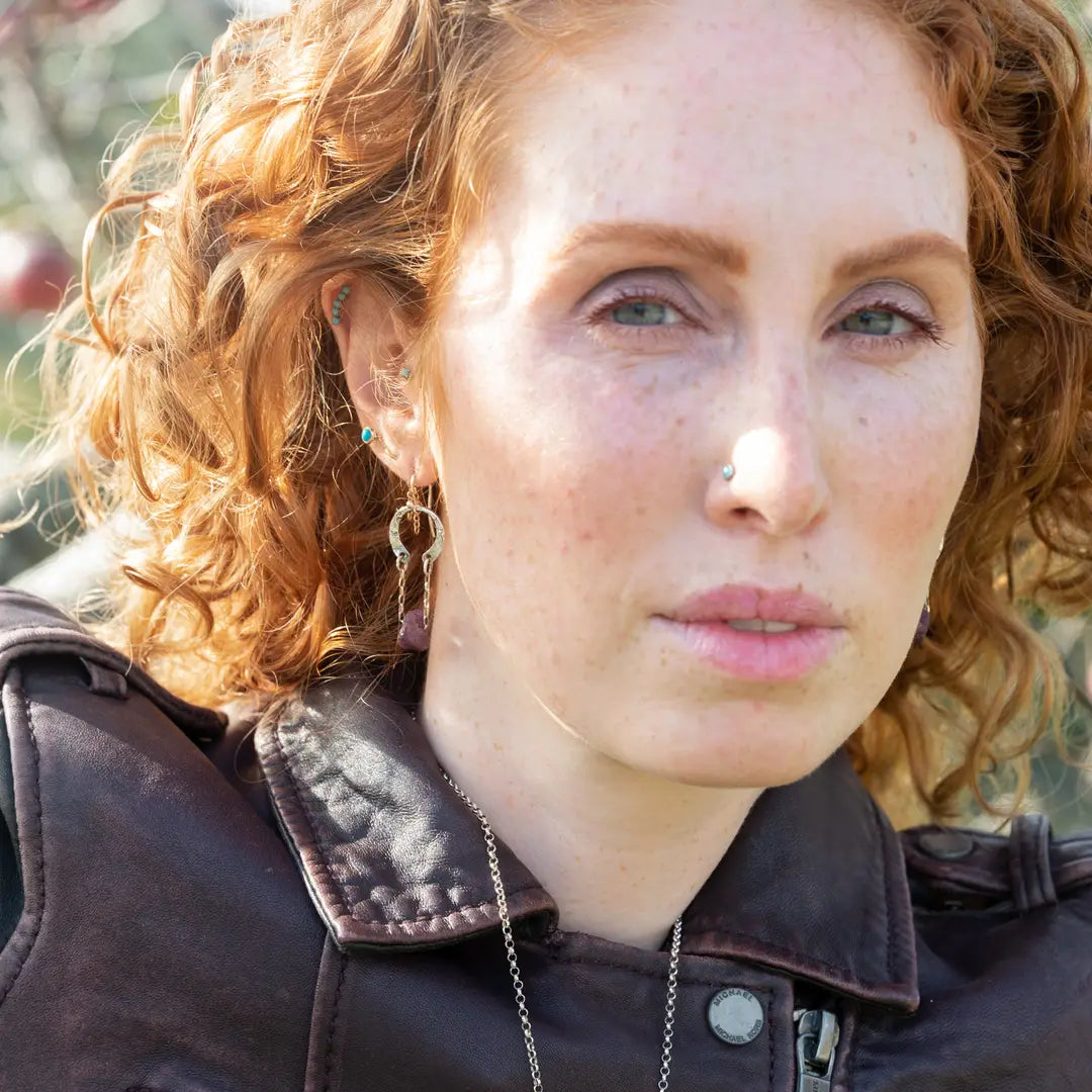 raw ruby nugget gemstones on sterling silver chain hanging from sterling silver horseshoe shaped earrings