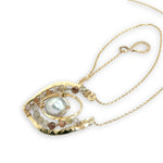 Brass textured pendant with fresh water pearl center, accented with rutilated quartz gemstones on gold filled delicate chain necklace