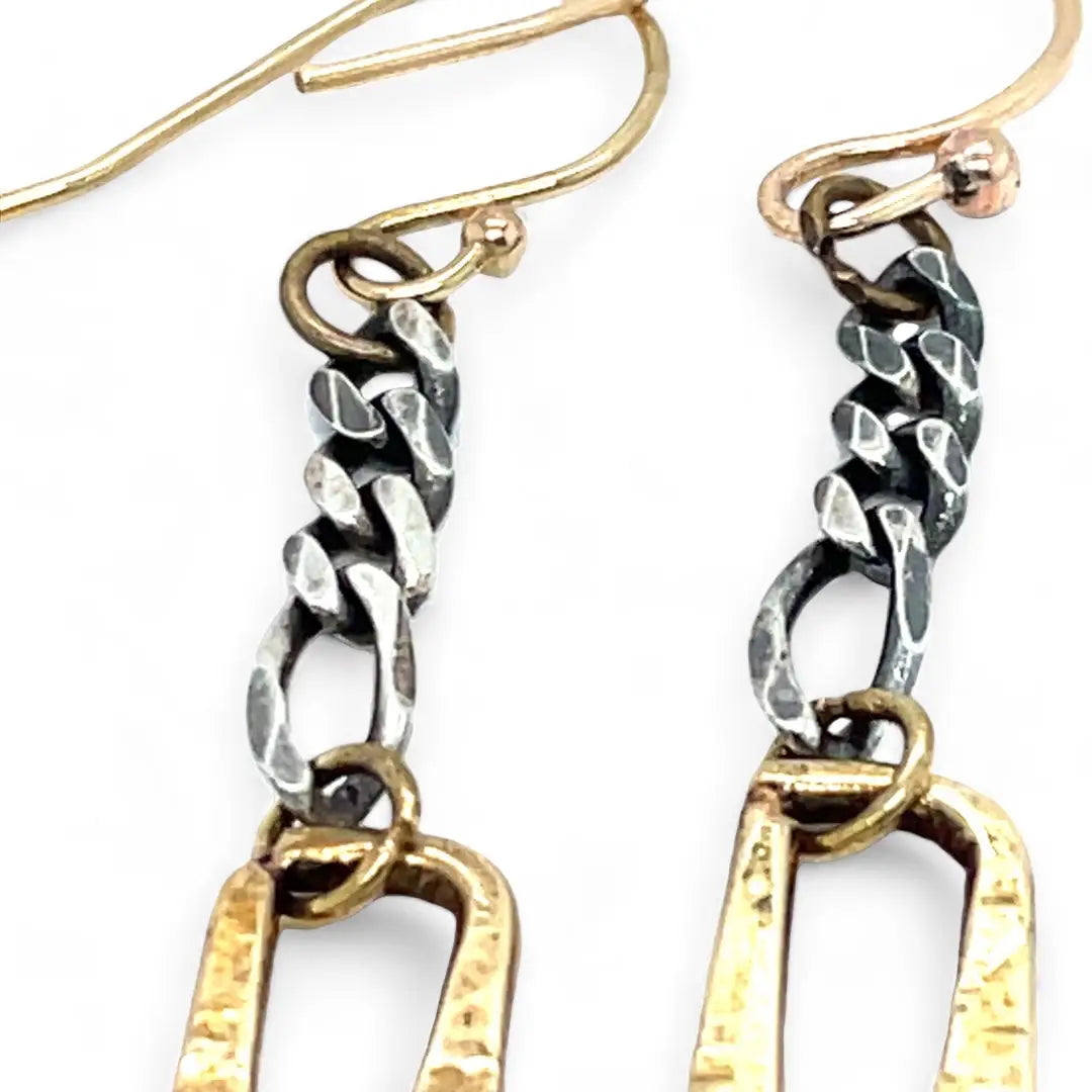 A pair of earrings featuring shiny brass rectangles attached to oxidized sterling silver chains, with gold filled French hooks.