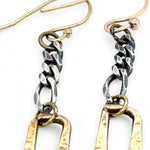 A pair of earrings featuring shiny brass rectangles attached to oxidized sterling silver chains, with gold filled French hooks.