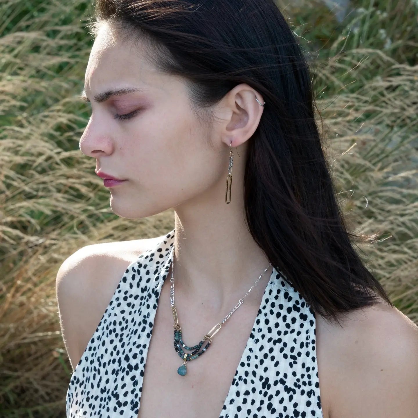 A pair of earrings featuring shiny brass rectangles attached to oxidized sterling silver chains, with gold filled French hooks.