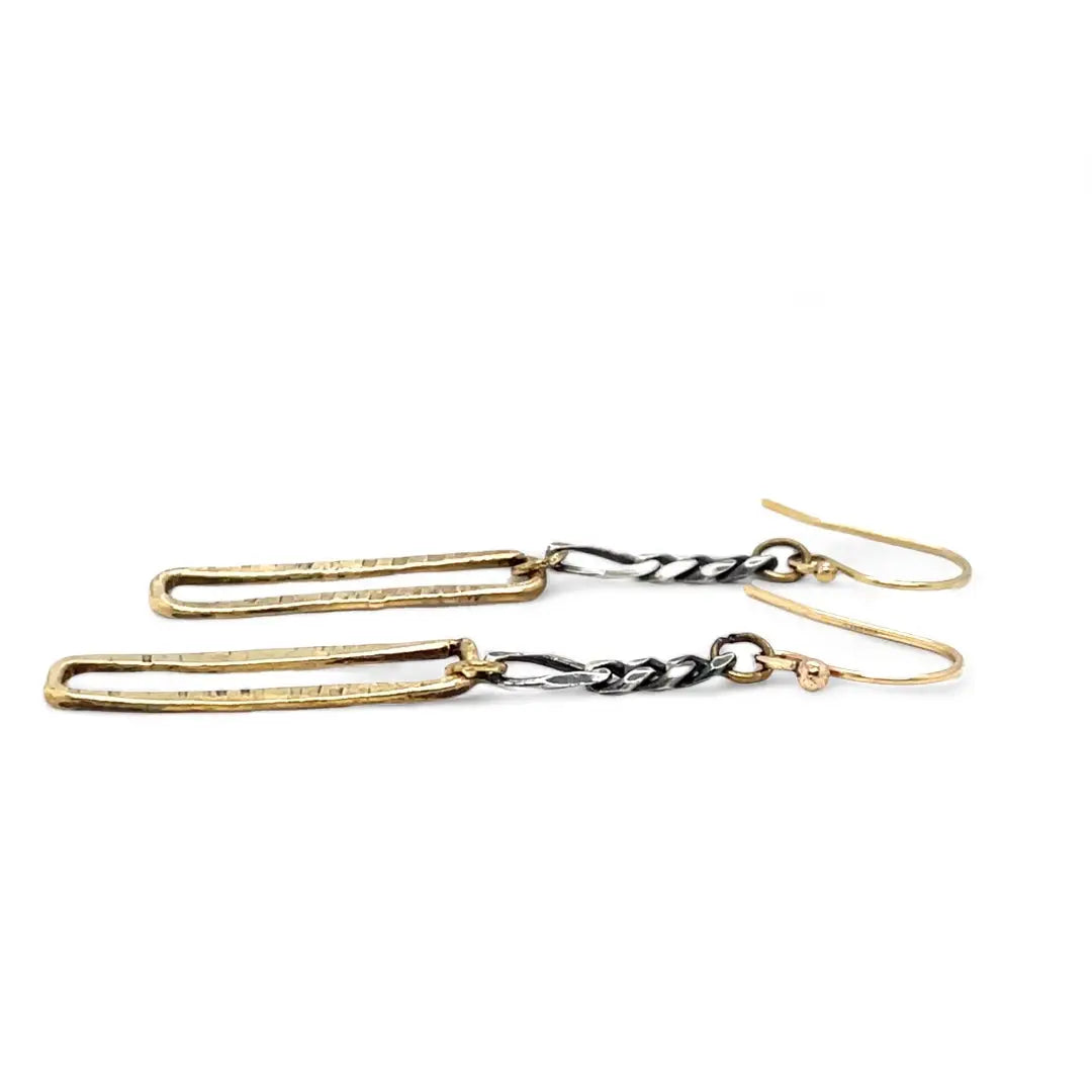 A pair of earrings featuring shiny brass rectangles attached to oxidized sterling silver chains, with gold filled French hooks.