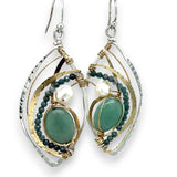 A pair of sterling silver marquise earrings with blue tourmaline gemstones, fresh water pearl, and jade set in hammered brass with silver french hooks.