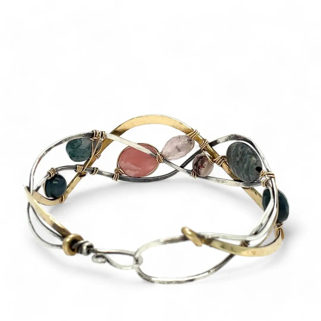 A oxidized sterling. brass, and sterling silver hammered wave bracelet featuring rhodochrosite, rose quartz, bloodstone, moss agate, and jasper gemstones on gold filled wire