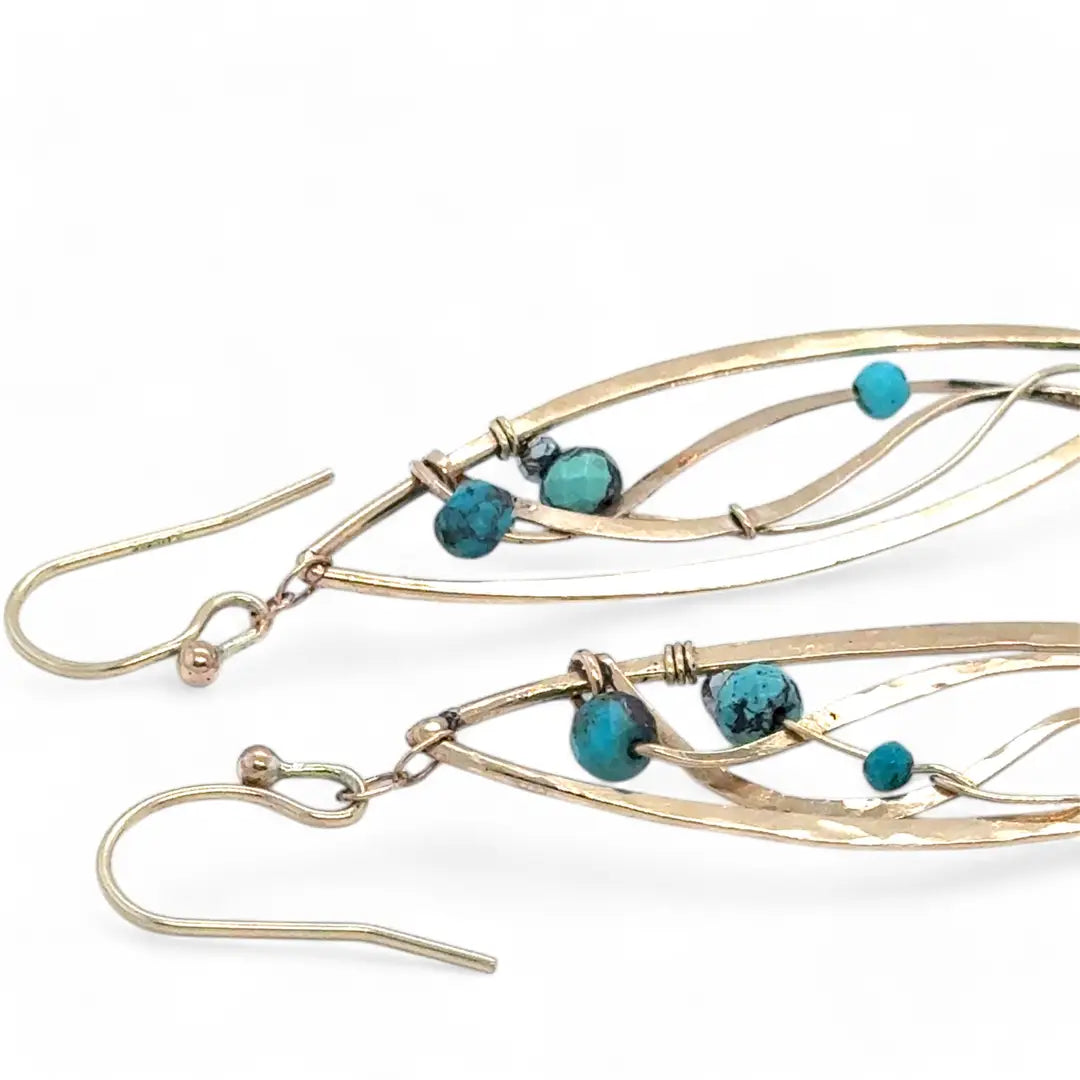 A pair of dangle bronze marquise earrings featuring hammered bronze and gold-filled designs with tiny faceted turquoise and chrysocolla gemstones.