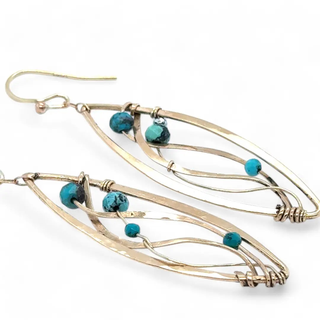 A pair of dangle bronze marquise earrings featuring hammered bronze and gold-filled designs with tiny faceted turquoise and chrysocolla gemstones.