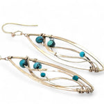 A pair of dangle bronze marquise earrings featuring hammered bronze and gold-filled designs with tiny faceted turquoise and chrysocolla gemstones.