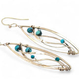 A pair of dangle bronze marquise earrings featuring hammered bronze and gold-filled designs with tiny faceted turquoise and chrysocolla gemstones.
