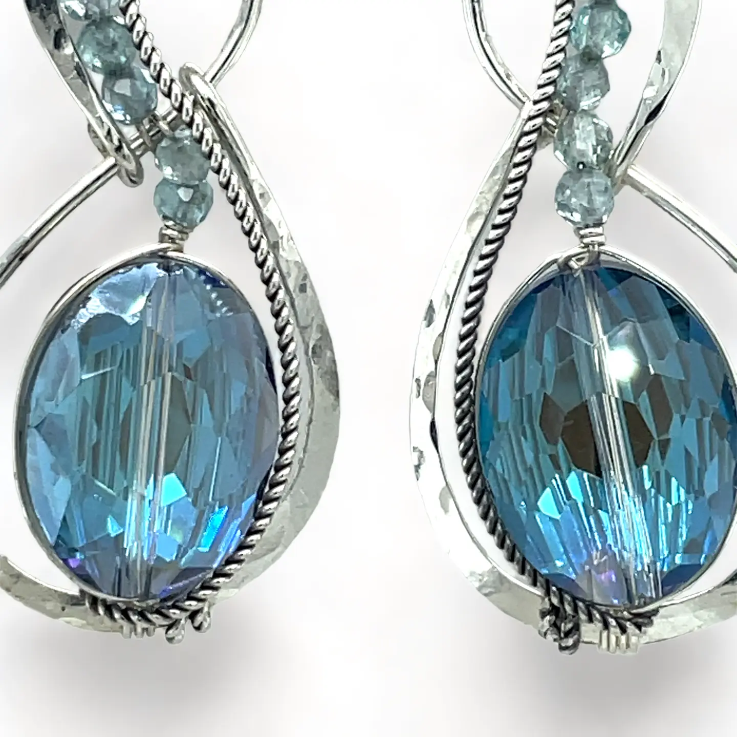 Pair of infinity shaped sterling silver earrings with blue crystal and apatite.