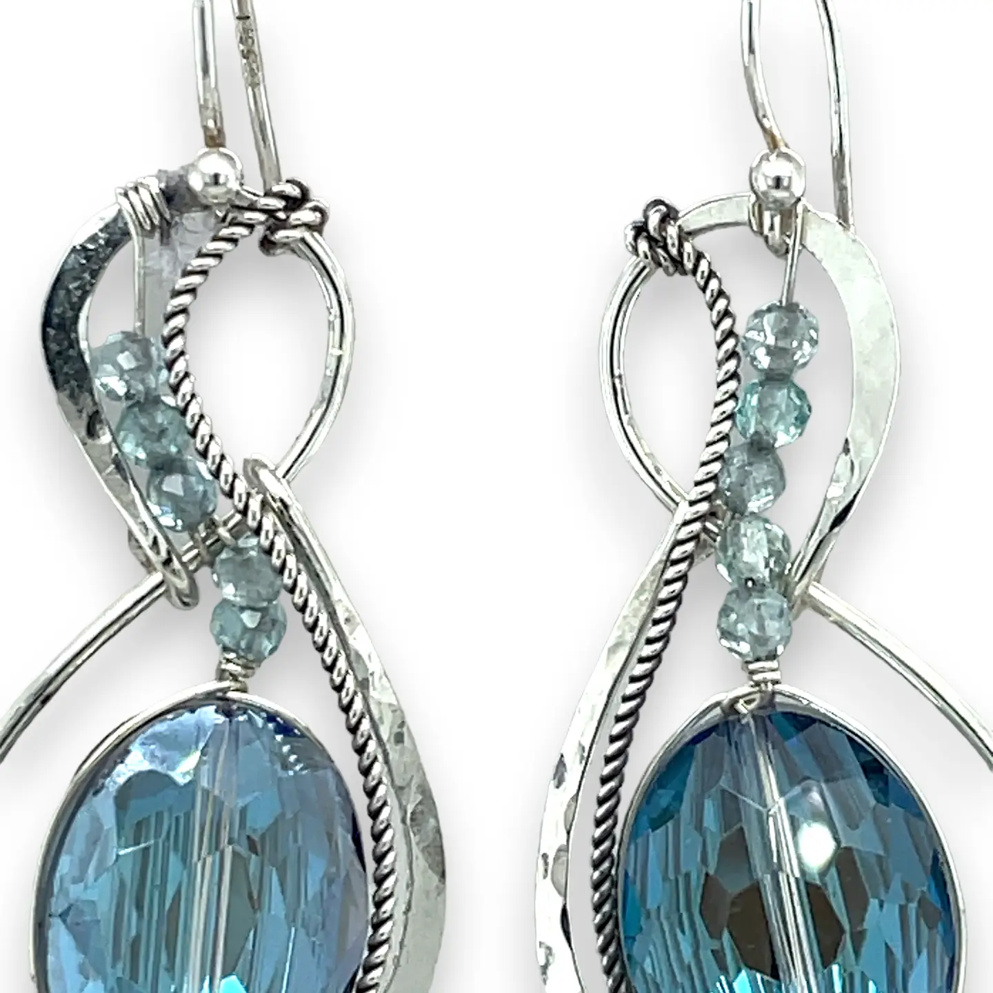 Pair of infinity shaped sterling silver earrings with blue crystal and apatite.