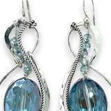 Pair of infinity shaped sterling silver earrings with blue crystal and apatite.