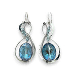 Pair of infinity shaped sterling silver earrings with blue crystal and apatite.