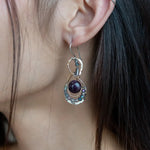 smooth dark purple fluorite coins encircled with fluorite faceted gemstones and crystal accents within mini bronze infinity earrings