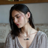 smooth dark purple fluorite coins encircled with fluorite faceted gemstones and crystal accents within mini bronze infinity earrings