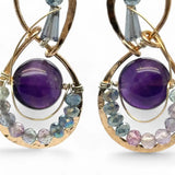 smooth dark purple fluorite coins encircled with fluorite faceted gemstones and crystal accents within mini bronze infinity earrings