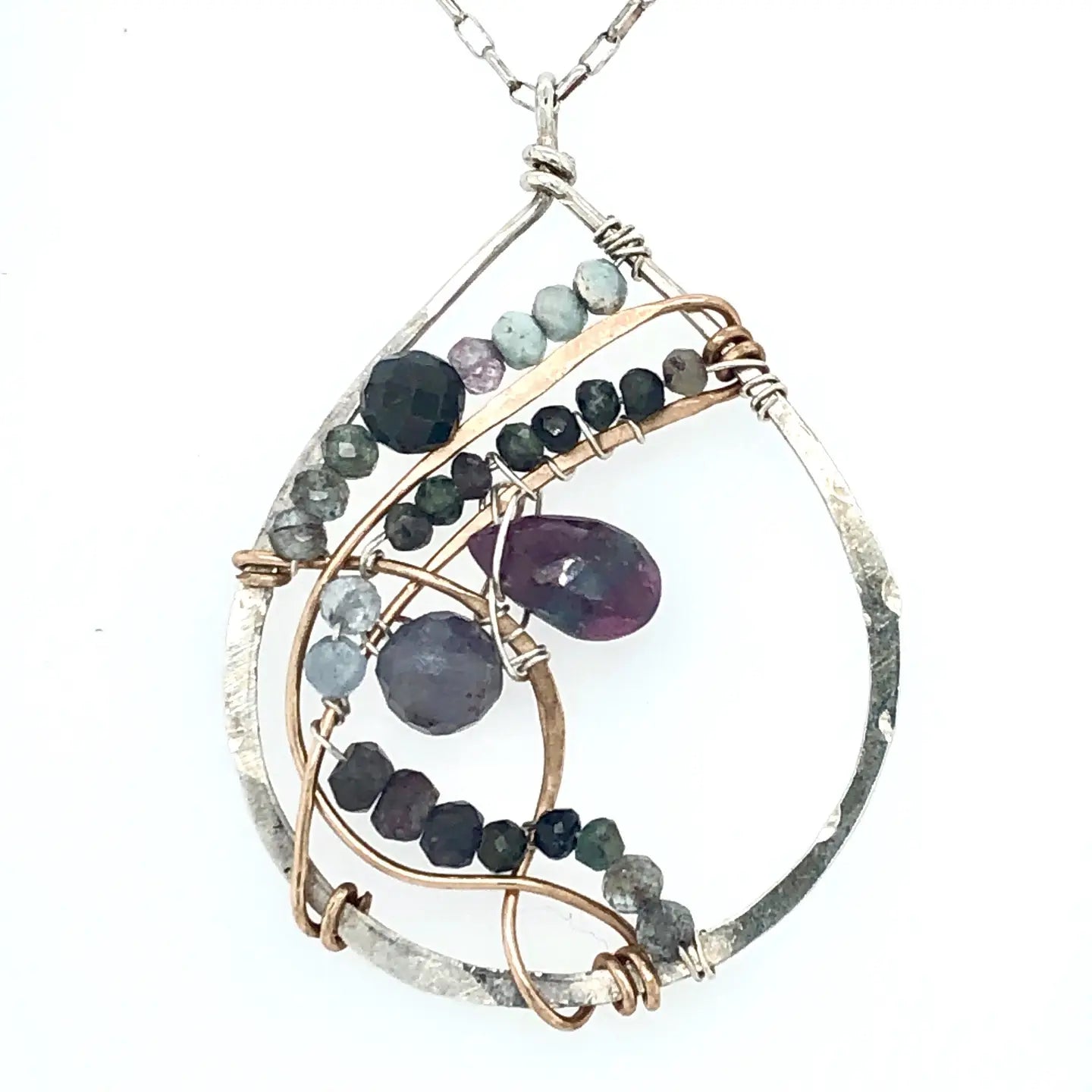 Fat sterling silver pendant with bronze wire, ruby zoisite, iolite, labradorite, apatite, and aquamarine on a long box chain with beaded swirls embedded into the chain