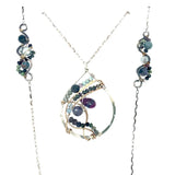 Fat sterling silver pendant with bronze wire, ruby zoisite, iolite, labradorite, apatite, and aquamarine on a long box chain with beaded swirls embedded into the chain