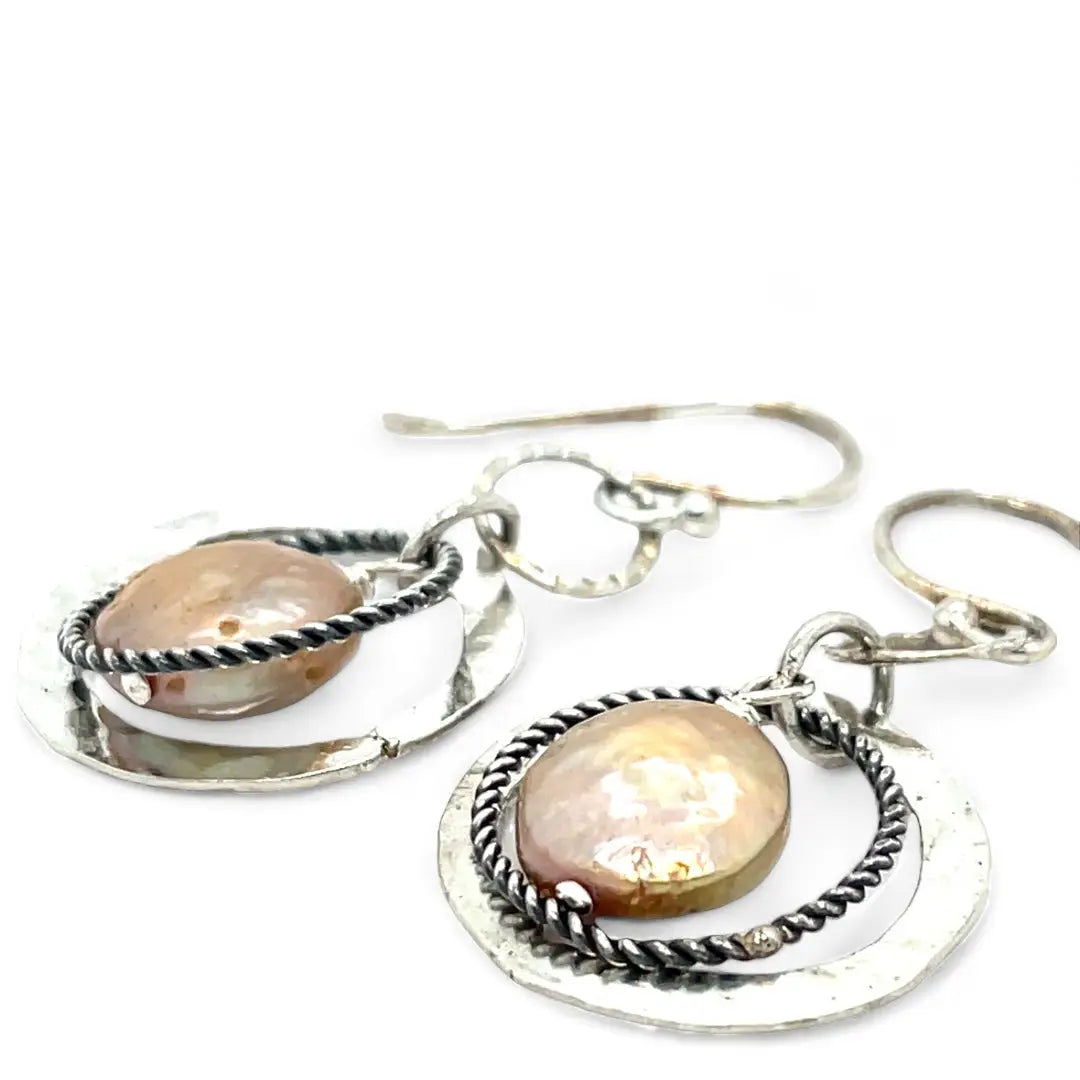 Handmade hammered and stamped sterling silver mini ring earrings with oxidized sterling silver twist rings holding a dangling champagne nude fresh water pearl coin
