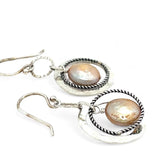 Handmade hammered and stamped sterling silver mini ring earrings with oxidized sterling silver twist rings holding a dangling champagne nude fresh water pearl coin