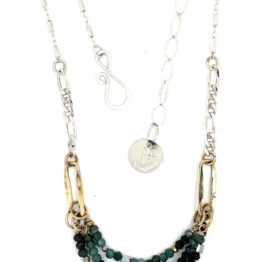 A necklace with blue tourmaline faceted ombre gemstones and silver crystal cubes, featuring a moss agate drop, hammered brass rectangle links, and a handmade hammered brass strap on sterling silver chain
