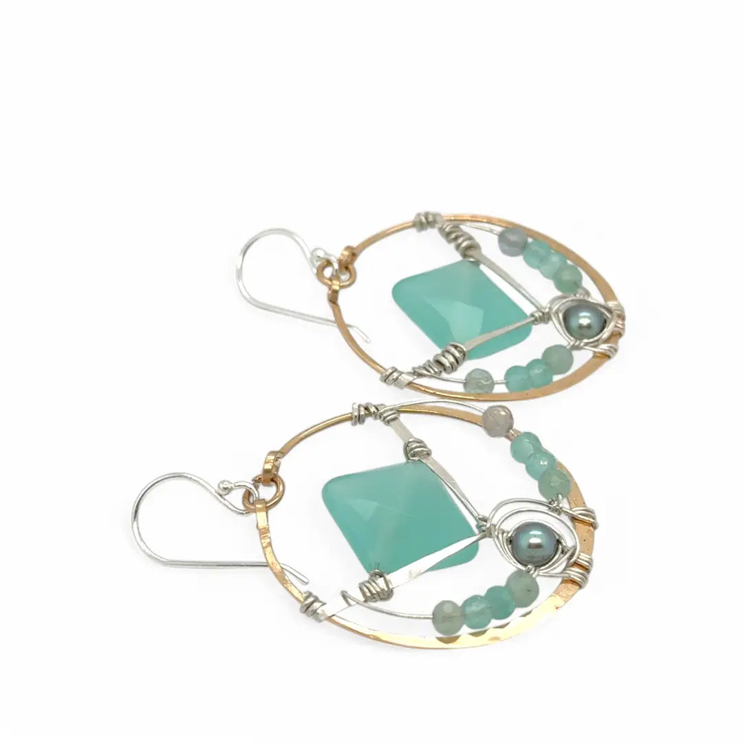 A pair of bronze hoop earrings with hammered sterling silver details and chalcedony gemstones, accented with silver blue fresh water pearls and fluorite gemstones