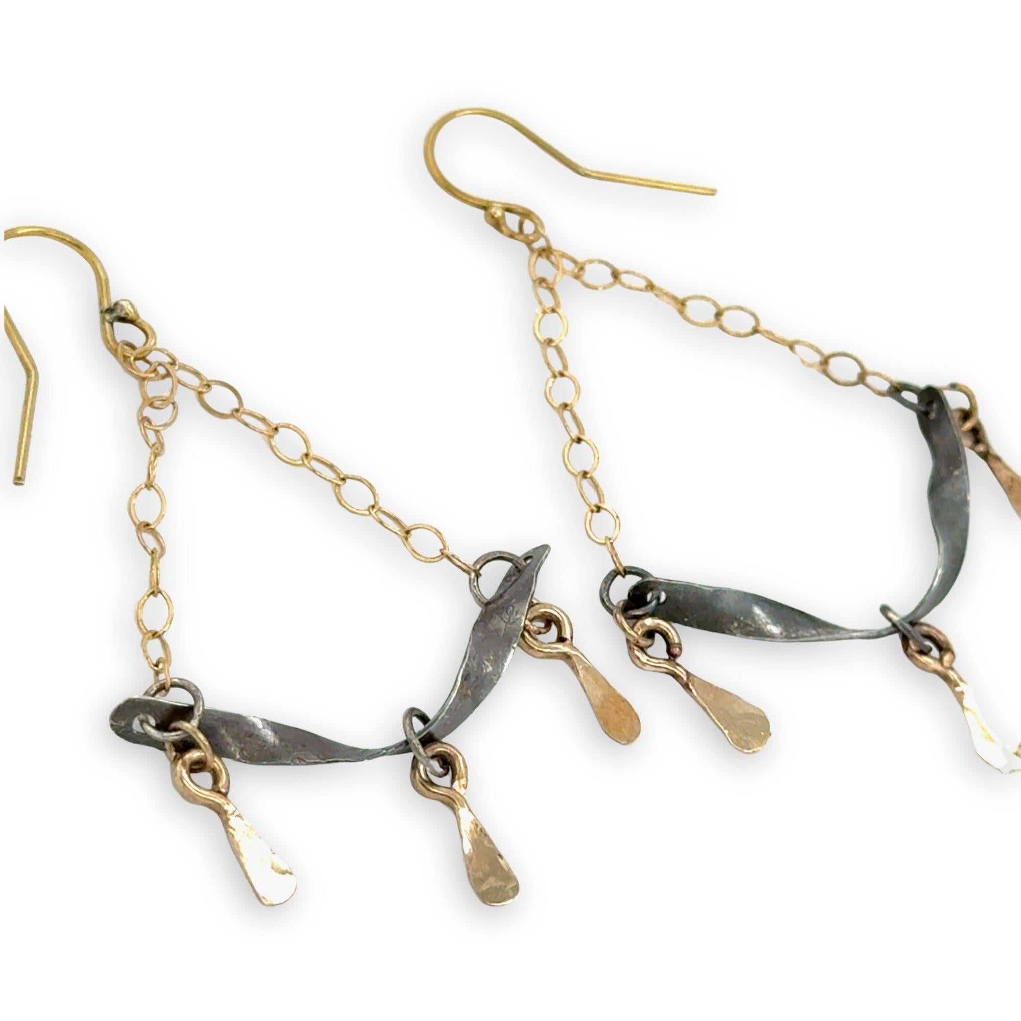 Stamped, hammered, and oxidized sterling silver twisted bars hanging from delicate gold chain with handmade gold filled paddle charm earrings