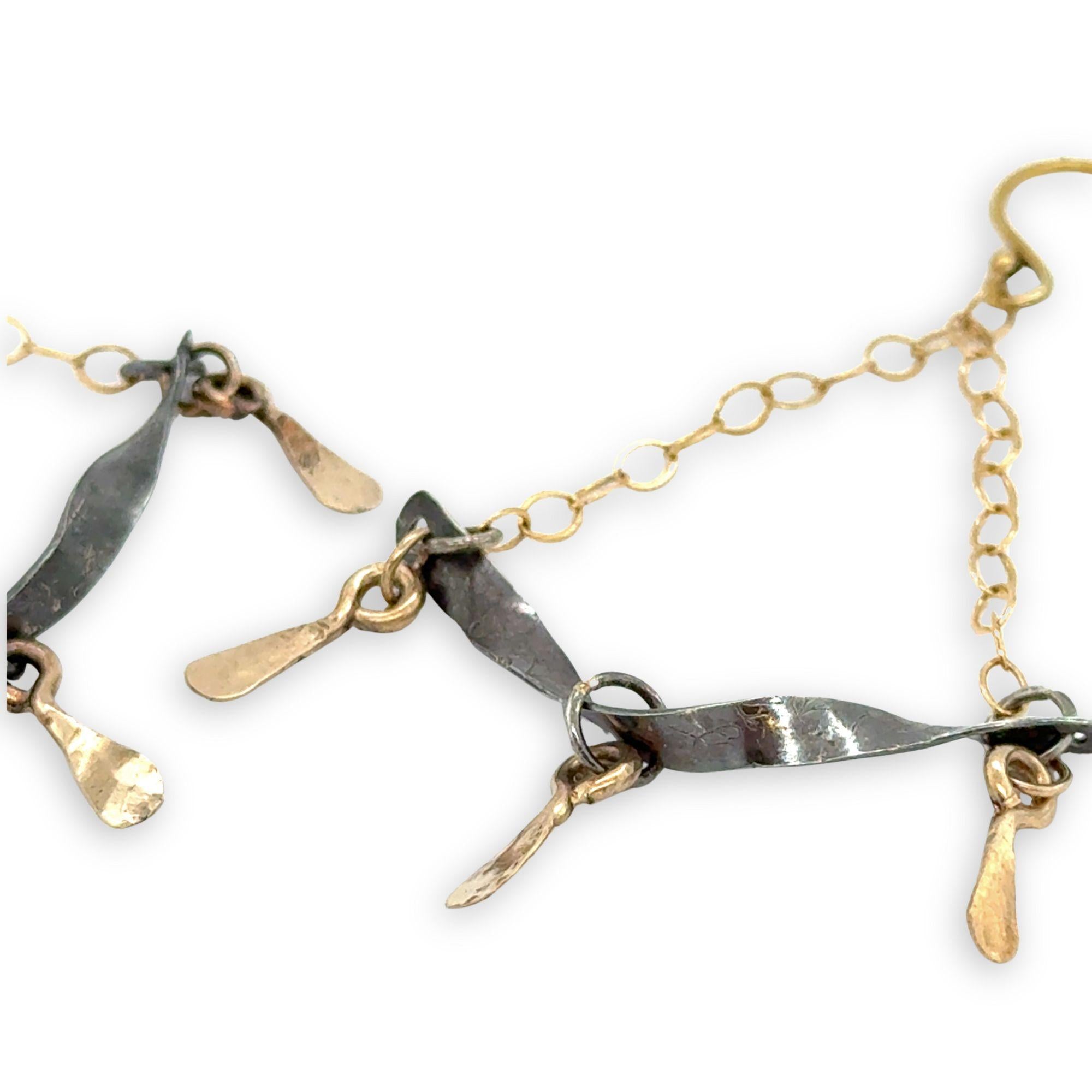 Stamped, hammered, and oxidized sterling silver twisted bars hanging from delicate gold chain with handmade gold filled paddle charm earrings