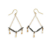 Stamped, hammered, and oxidized sterling silver twisted bars hanging from delicate gold chain with handmade gold filled paddle charm earrings