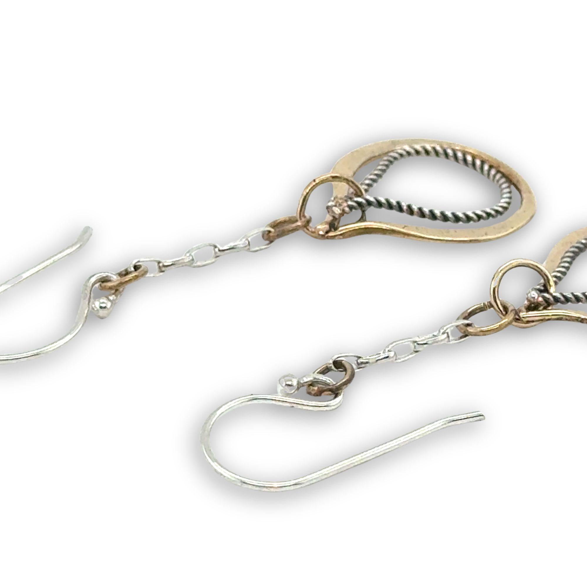 Hammered brass and oxidized sterling silver twist drop earrings on dainty chain