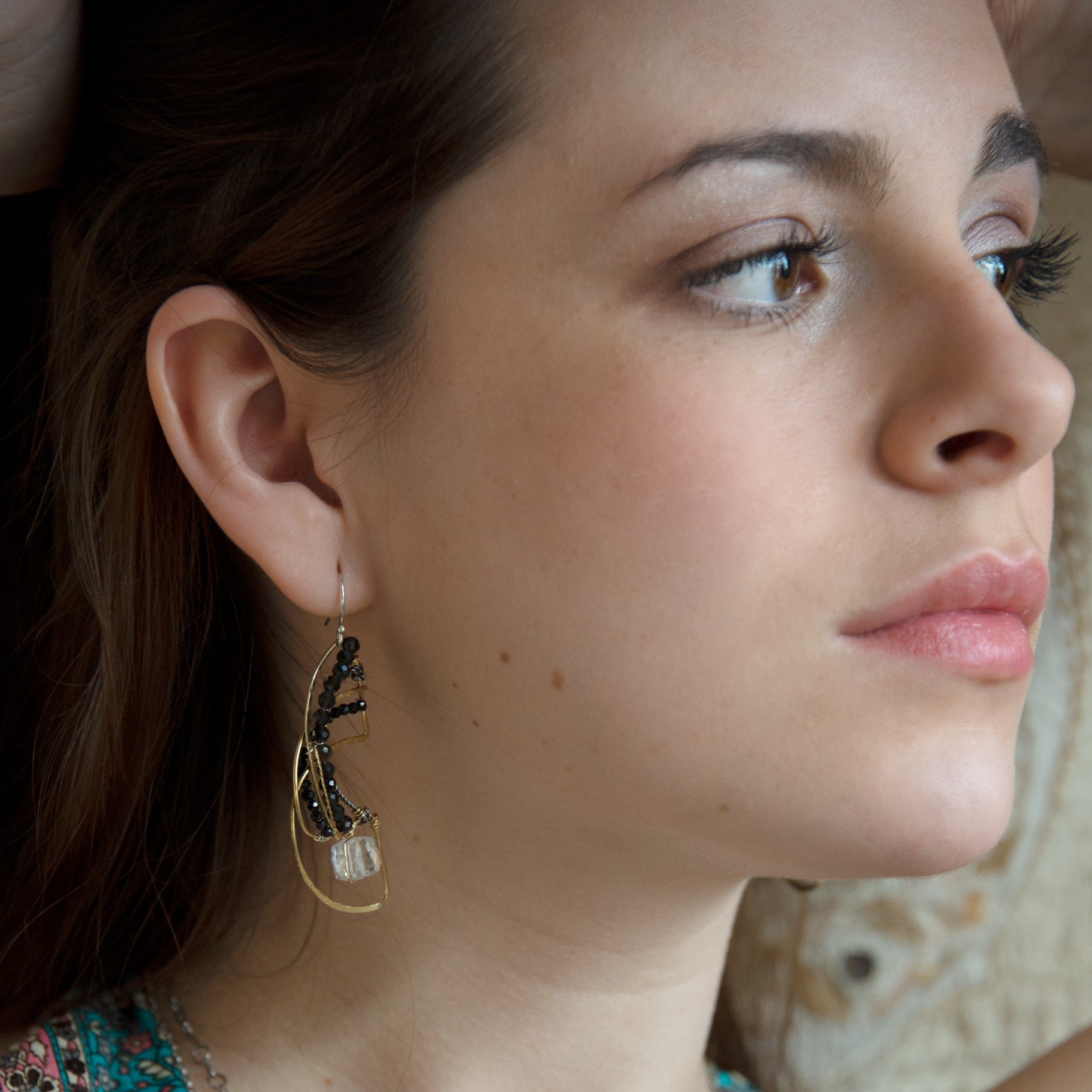Brass hammered earrings line with dark olive cat's eye, black spinel, and quartz cube gemstones