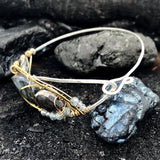 Flashy labradorite, pyrite, and apatite gemstones share space within a sterling silver and brass cuff bracelet with gold filled wire