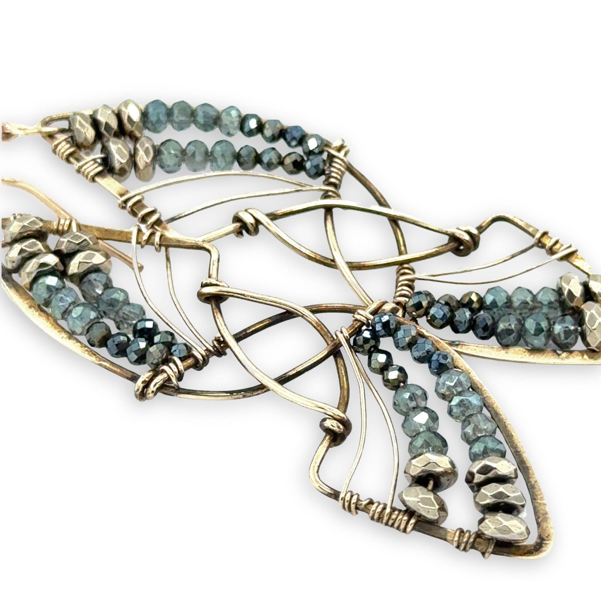 Pyrite gemstones and crystal on gold filled wire decorate brass interlocking frames to form a shooting star on gold filled earring hooks